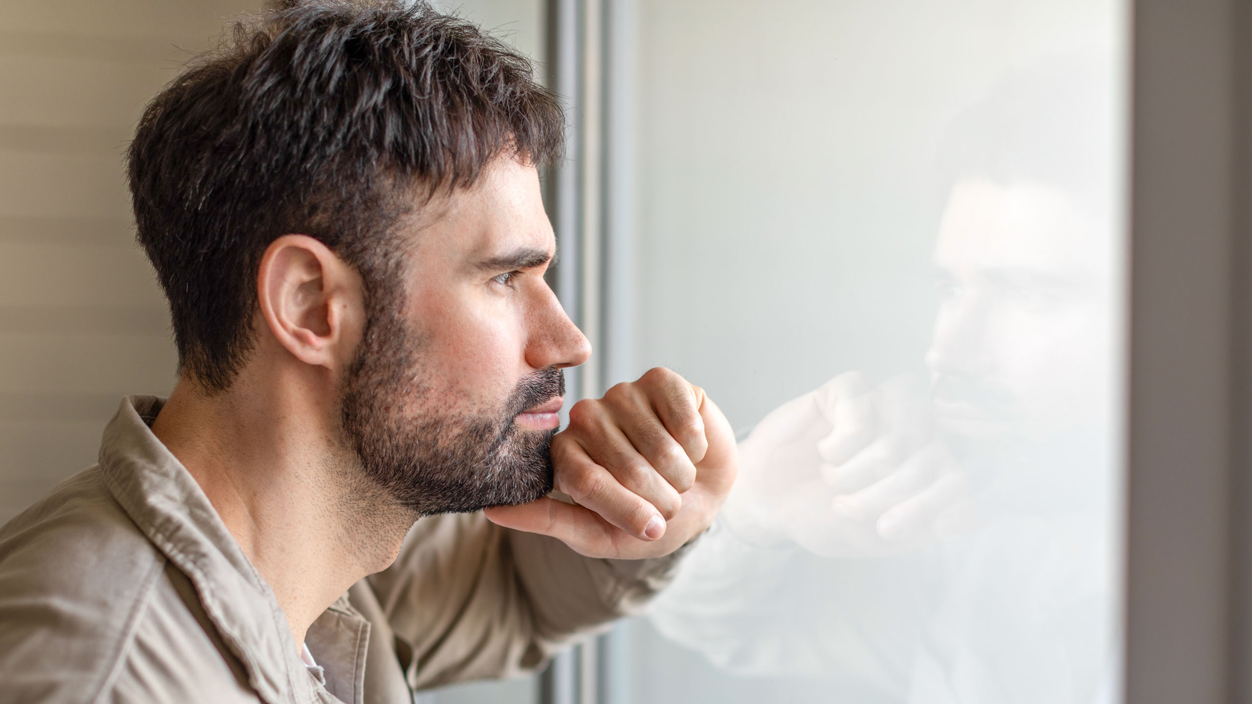 man looking out of window