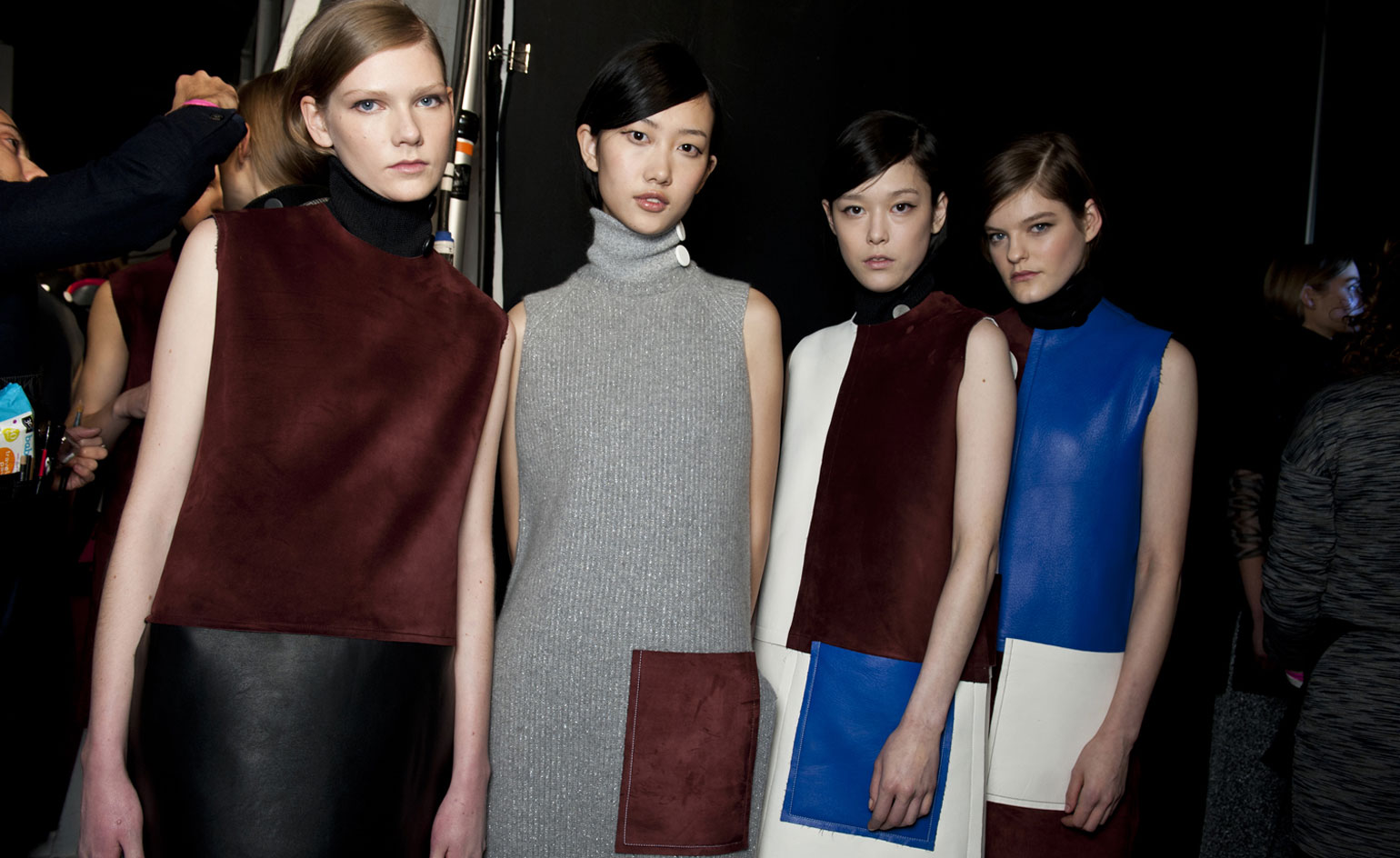 Edun models wearing high neck clothing