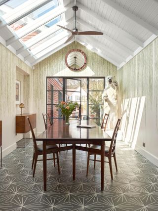 Dining room with botanical wallpaper and pattern tile flooring
