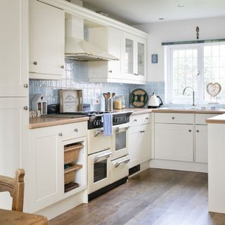 kitchen room with wooden worktop and white cabinets