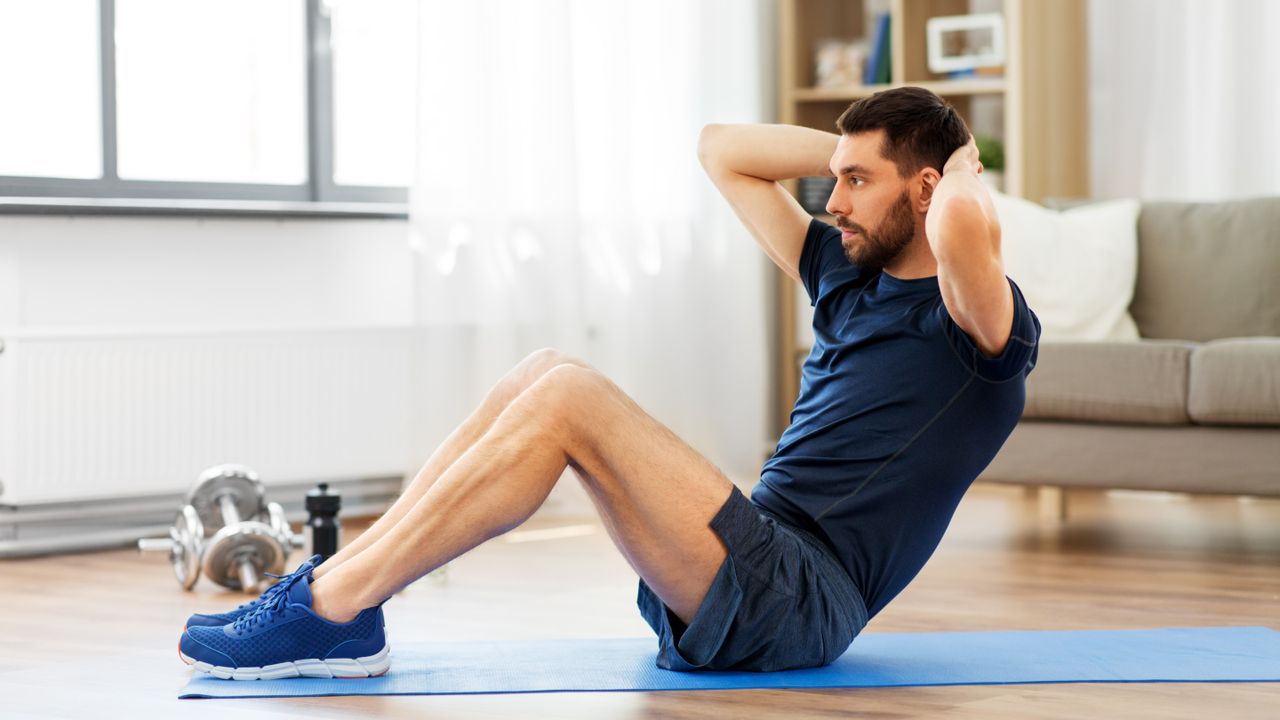 A photo of a young man doing sit ups