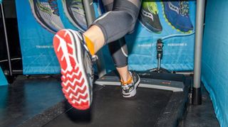 Close-up of camera mounted by a treadmill’s belt to conduct gait analysis on a runner