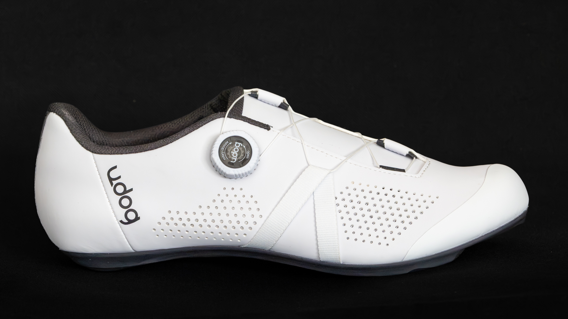 White road cycling shoe side on against a black background