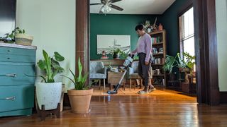 Reviewer using Levoit Aero vacuum to clean her living space