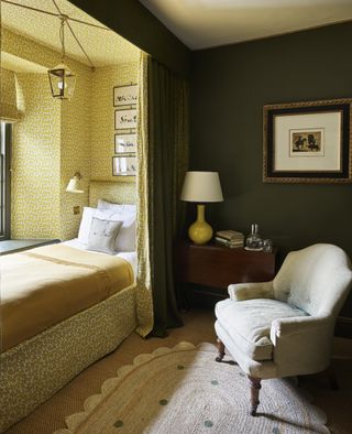 A dark green bedroom with a curtain that reveals a yellow space