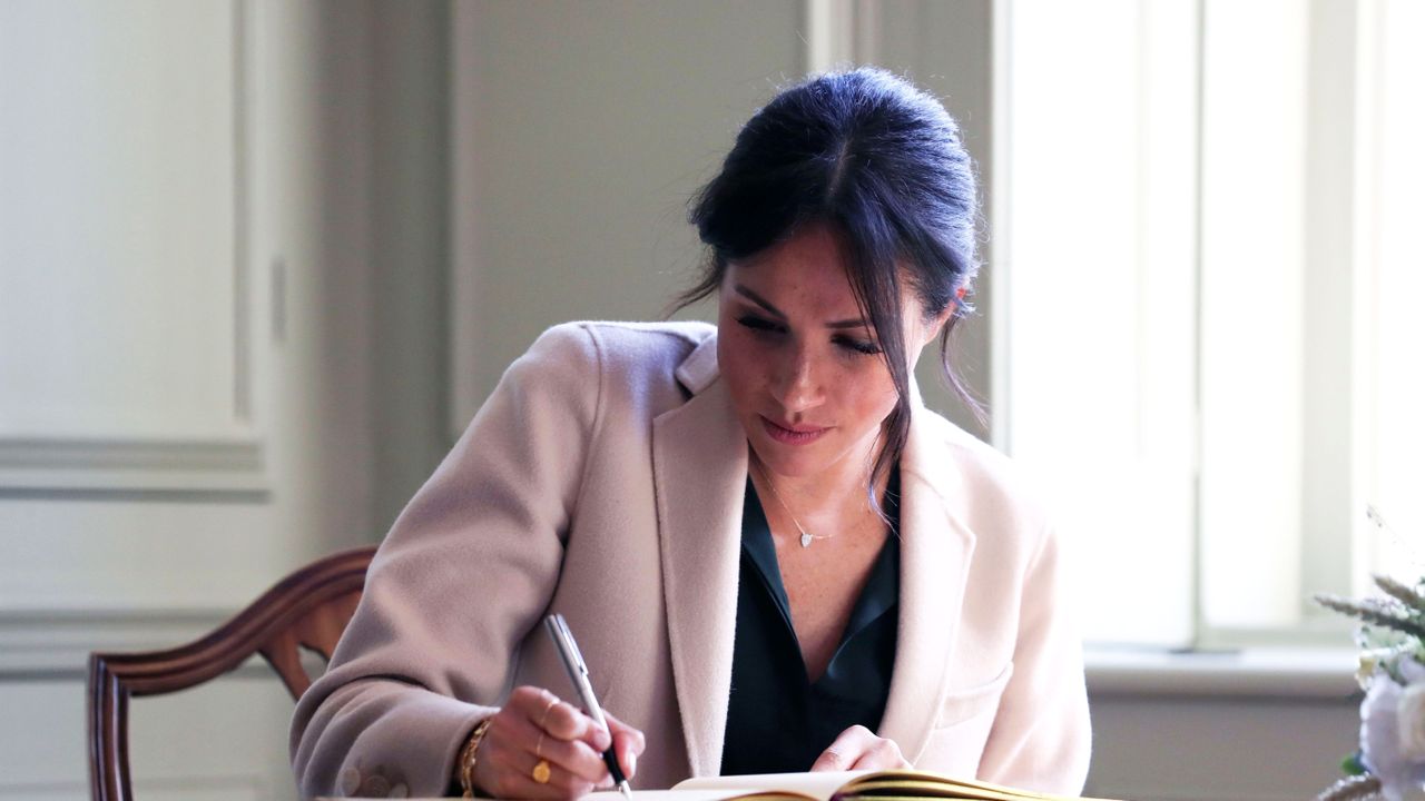 chichester, england october 3 meghan duchess of sussex signs the visitors book at edes house during an official visit to sussex on october 3, 2018 in chichester, england the duke and duchess married on may 19th 2018 in windsor and were conferred the duke duchess of sussex by the queen photo by daniel leal olivas wpa poolgetty images