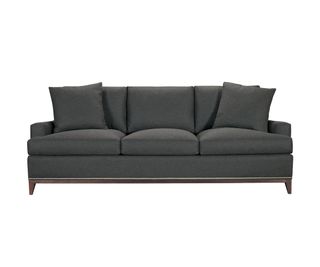 Three-seater dark gray couch with throw pillows