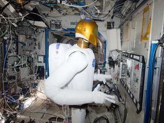 In the International Space Station's Destiny laboratory, Robonaut 2 is pictured on Jan. 2, 2013, during a round of testing for the first humanoid robot in space. Ground teams put Robonaut through its paces as they remotely commanded it to operate valves on a task board.