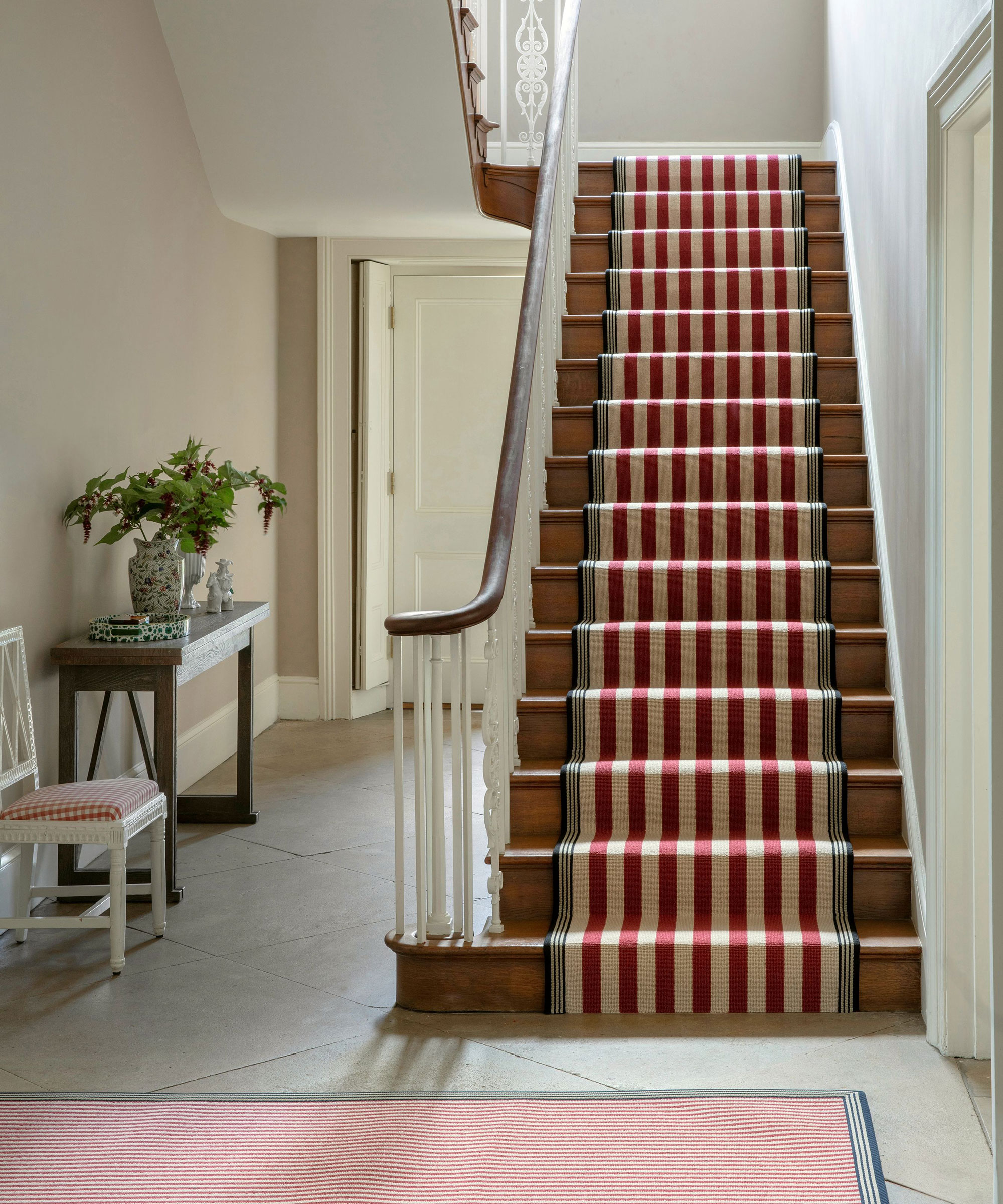 entrance hall with staircase with stripey runner