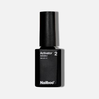 black bottle of Nailboo Dip Powder Activator Coat on a white background