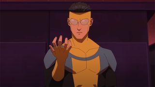 Still from the adult animated superhero T.V. show Invincible. Here we see 17-year-old superhero Invincible. He has short black hair slicked back. He has opaque lens over his eyes. He is wearing a skin-tight yellow suit with blue/green shoulders and dark gray arms. He is holding up his right hand and looking at it intensely.