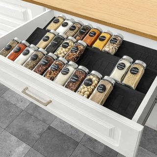 kitchen drawer with spice jars organised on a rack