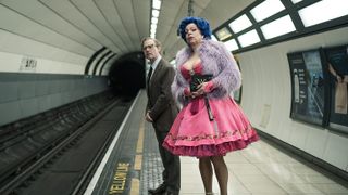 Characters from "Inside No. 9", including co-creator Steve Pemberton in a pink dress, waiting on an underground train platform