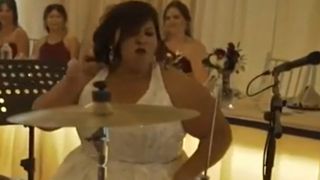 Bride performs drum solo in Wedding dress