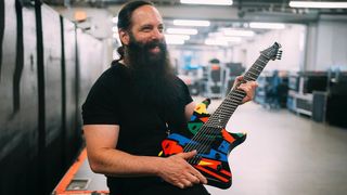 John Petrucci holding his custom Abasi Concepts Emi 8