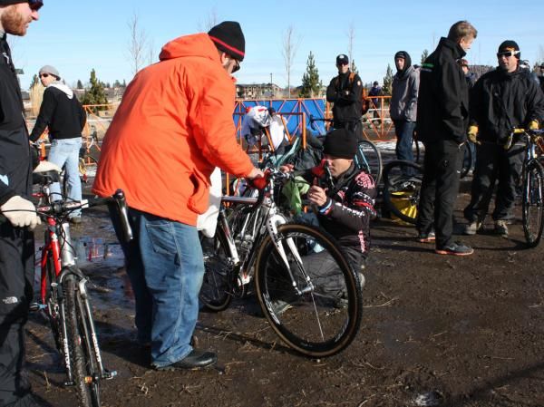 Mark Legg wipes off Katie Compton's (Planet Bike) bike after a wash in case it's needed again.