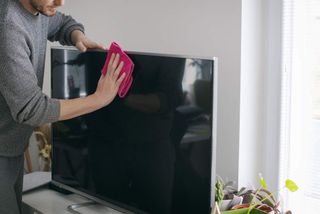  Close up of man cleaning TV screen
