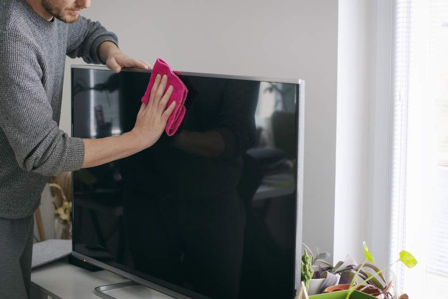  Close up of man cleaning TV screen