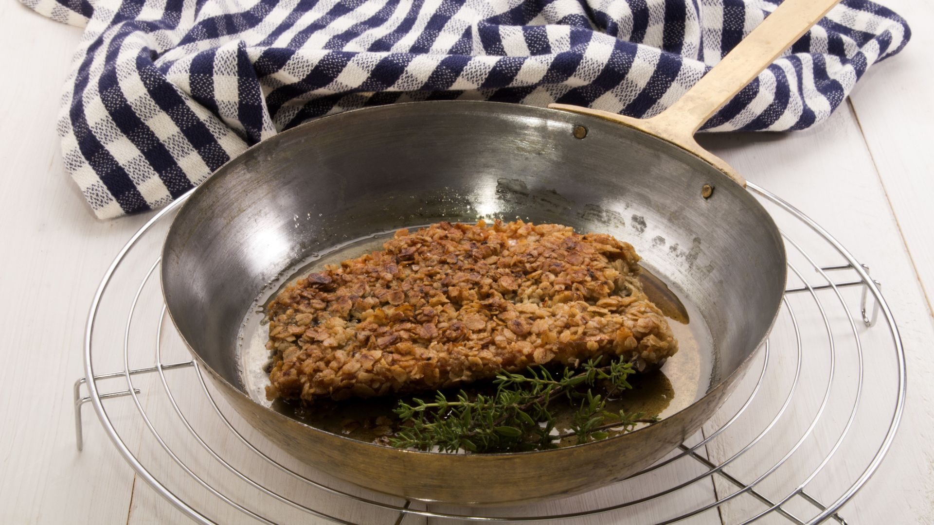 Herrings coated in oatmeal fried in a pan