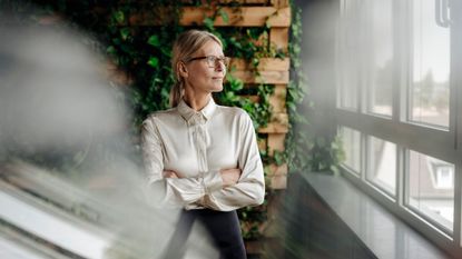 woman in workplace looking out of window