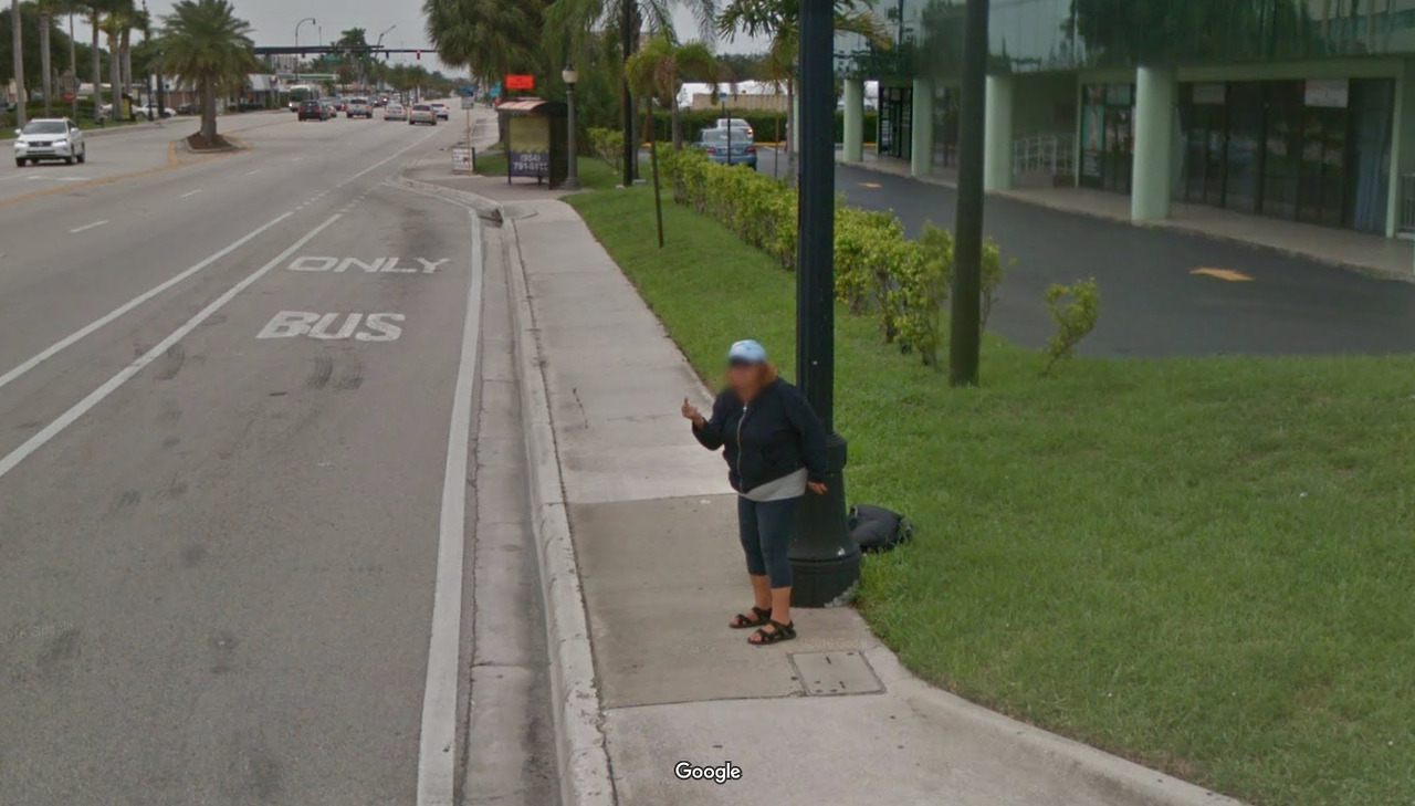 A woman giving the middle finger to the Google Street View camera