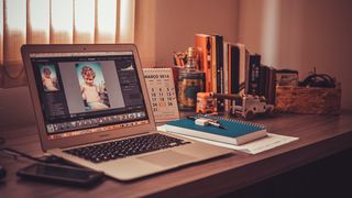 Best free video editing software - A MacBook is open on a wooden desk, running some free video software. 