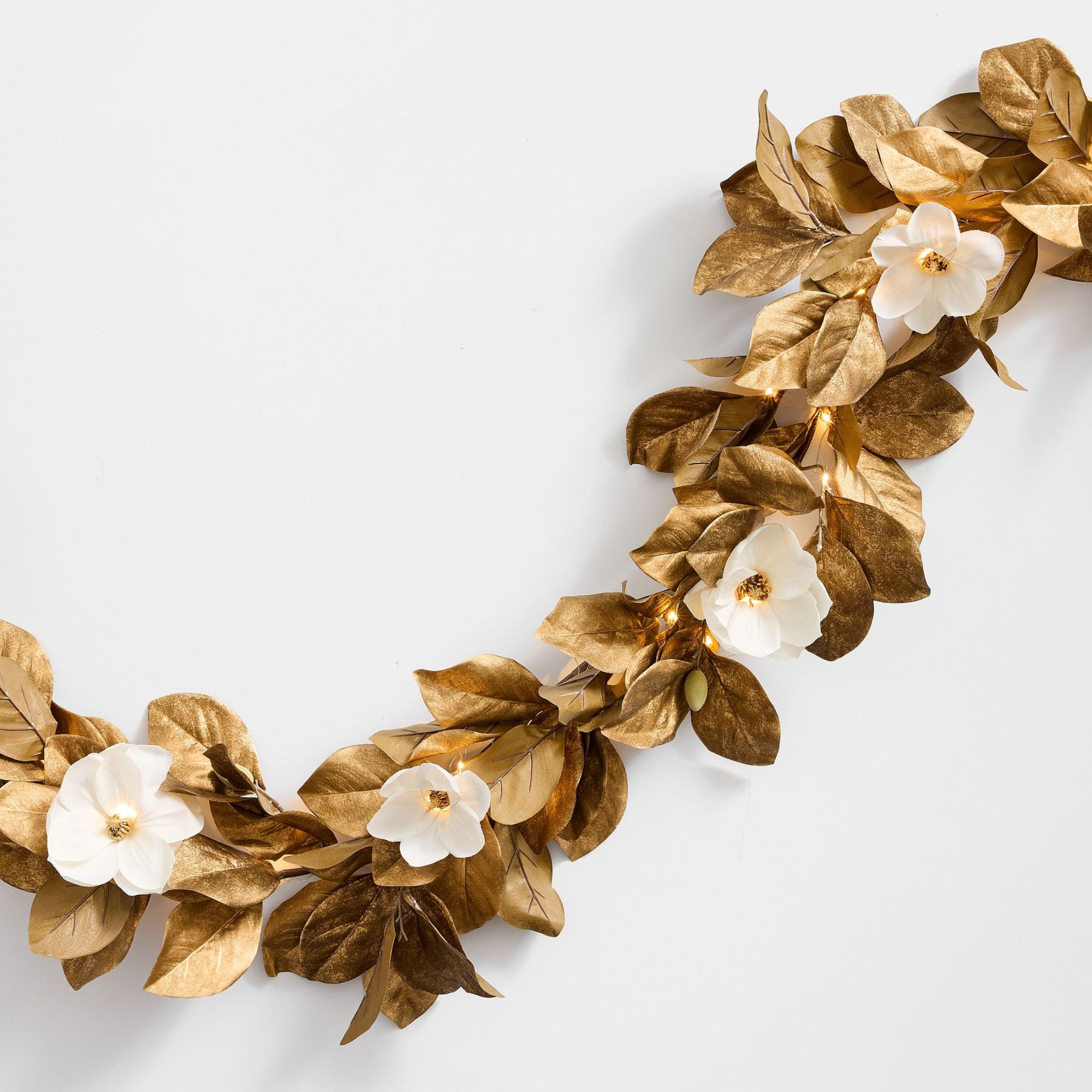Magnolia leaf garland with gold leaves and white flowers