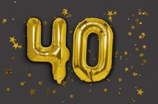 Gold balloons as the number 40 on a dark background littered with gold stars