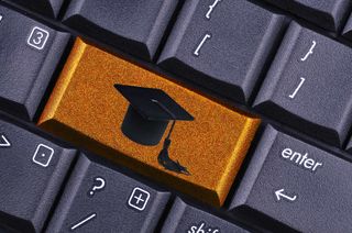 Keyboard with graduation cap on gold key