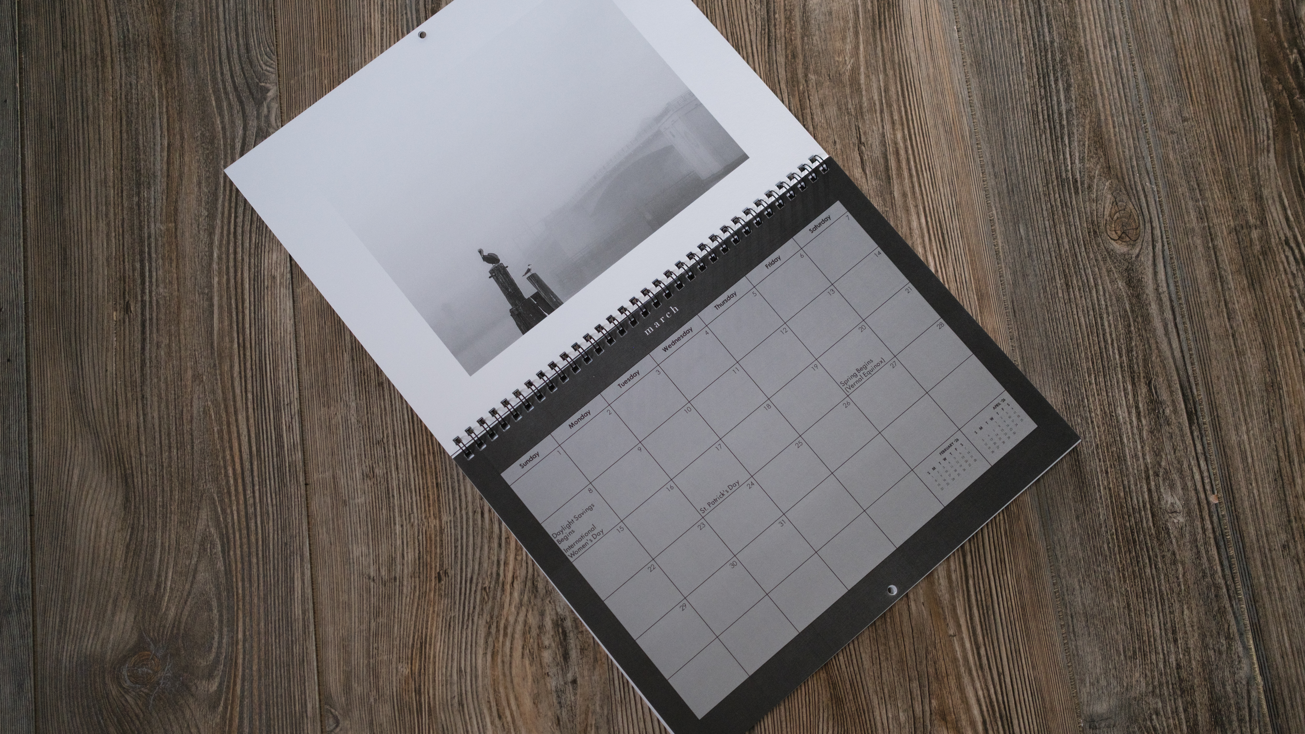 A photo calendar from Mixbook on a wood background