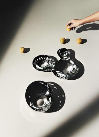 Zaha Hadid Design Tableware: steel perforated rounded bowls on white surface