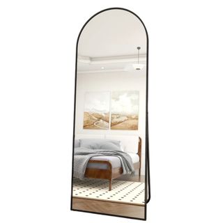 A black arched full length mirror