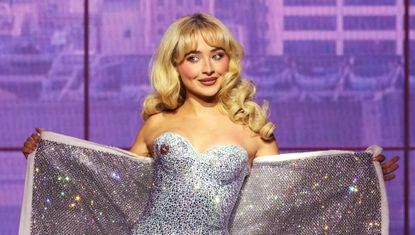 Sabrina Carpenter on the Short n Sweet stage wearing a diamond babydoll and a blue bustier