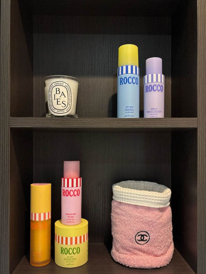 A bathroom shelf featuring Rocco Beauty products