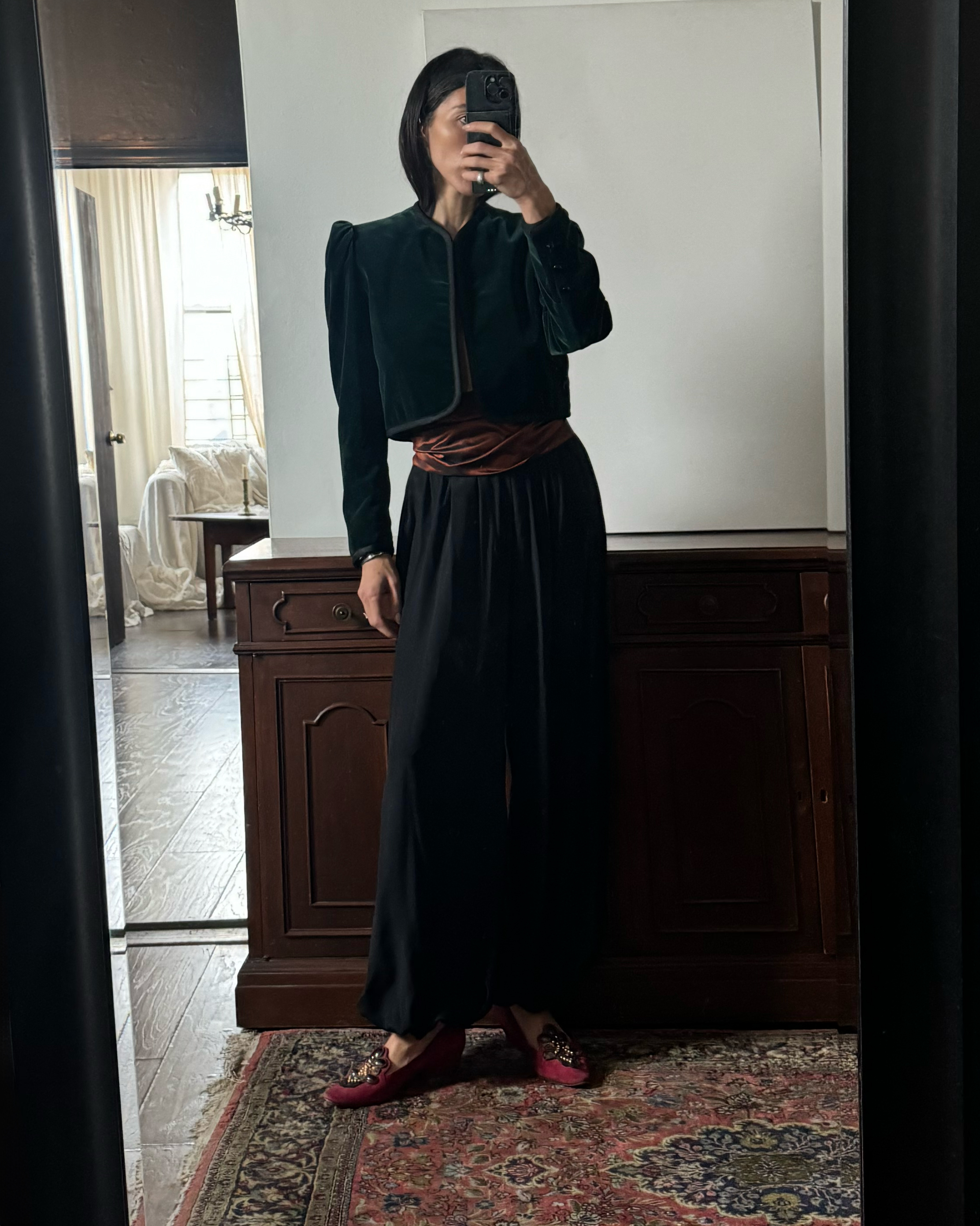 Alexis Badiyi wearing a cropped jacket in her apartment