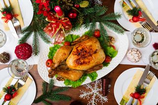 how to cook a turkey illustrated by a Christmas roast turkey on a decorated table