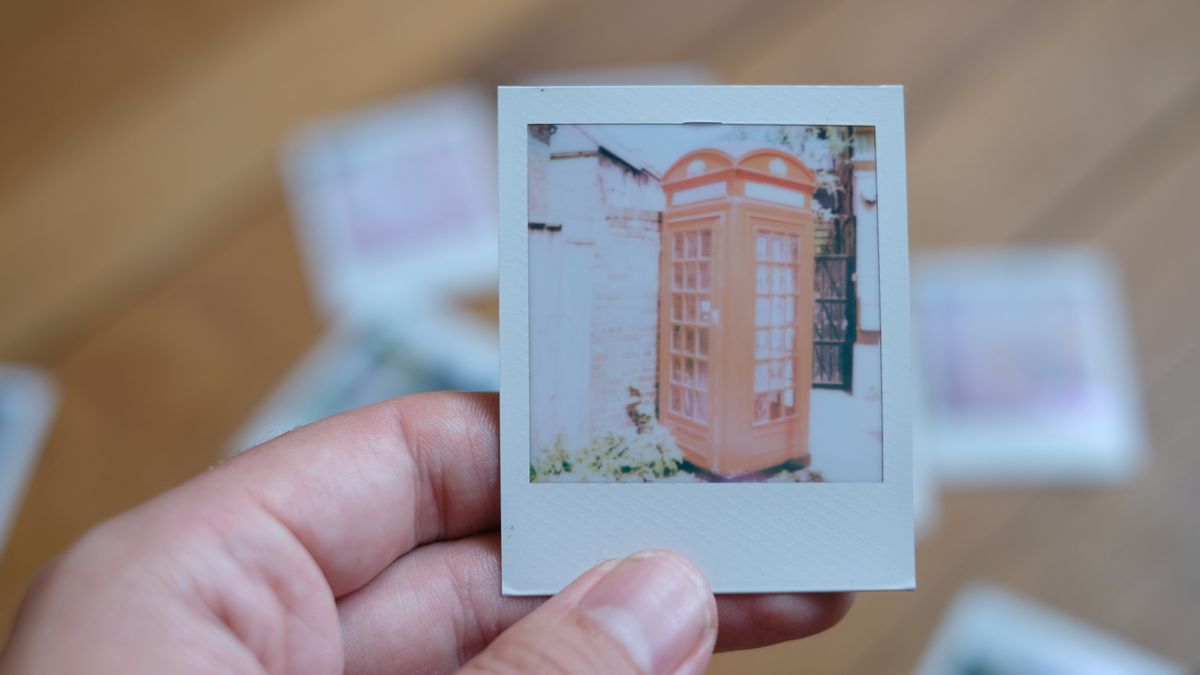 Photograph of prints made with Polaroid Go Gen 3 showing an overexposed red phone box