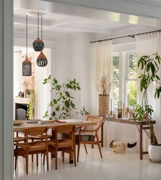 a boho dining room with sheer curtains