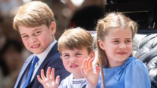 Prince George of Cambridge, Prince Louis of Cambridge and Princess Charlotte of Cambridge ride in a carriage during Trooping The Colour