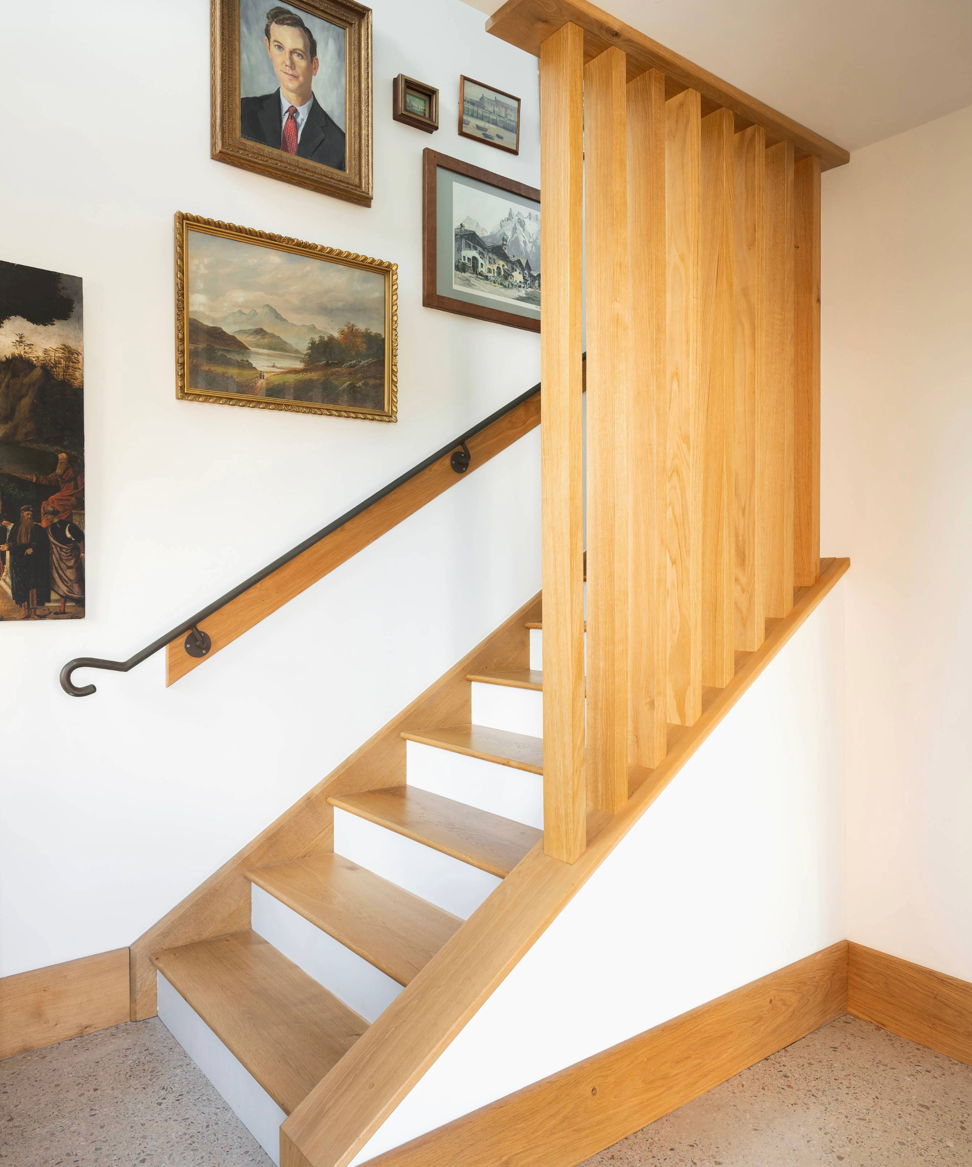 Wooden staircase with gallery wall