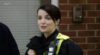 Eve Gordon as a police officer.