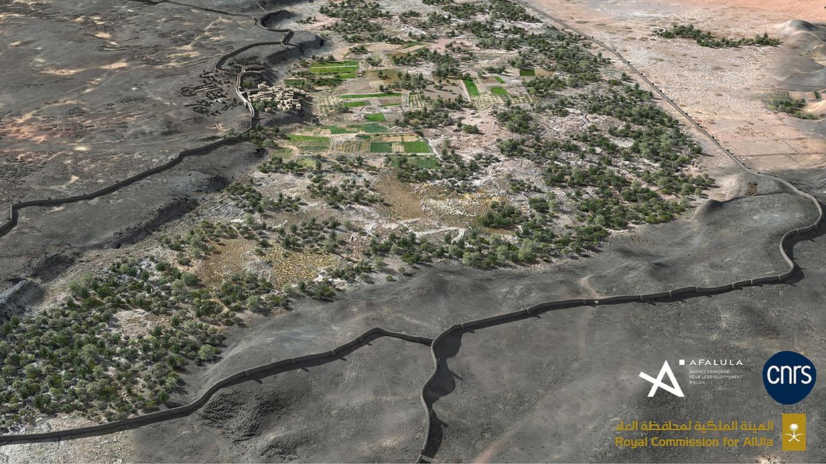 A reconstruction of a walled fortification with trees and fields in the center.