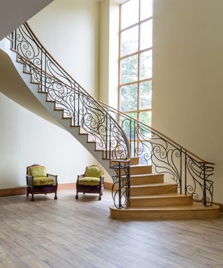 Bisca staircase railing design with scrolled steel and oval railing