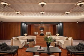The lobby boasts wooden walls and cream sofas