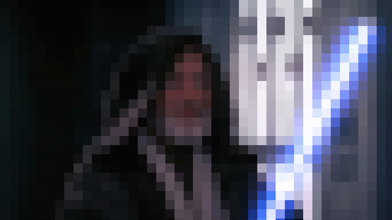 Alec Guinness stands with his lightsaber drawn in Star Wars, pixelated.