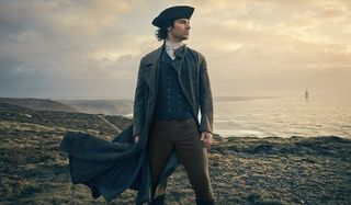 Poldark Aidan Turner looks out to the sea on a cliff