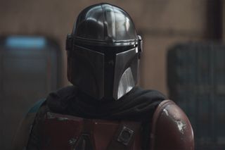 The Mandalorian accepts the deal on offer from the Client, and you can see the Client's inferior, non-Beskar shoulder armor before he replaces it.
