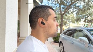 Tom's Guide reviewer wearing Sony InZone earbuds