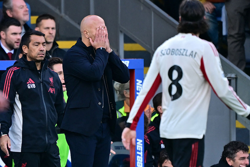 Arne Slot holds his face in his hands during Liverpool&#039;s defeat to Crystal Palace