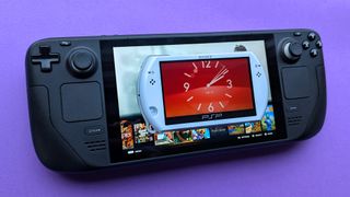 Sony PSP Go handheld resting above a Steam Deck on a purple card stock background